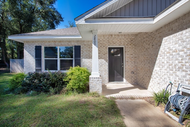 entrance to property with a yard