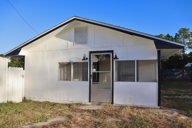 back of house with fence