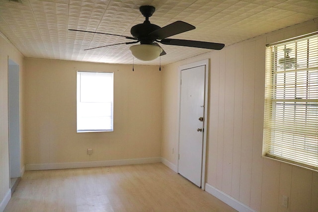 unfurnished room with ceiling fan and light wood-type flooring