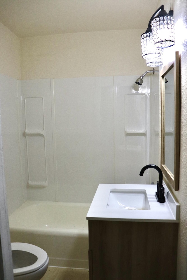 bathroom featuring shower / bathing tub combination, toilet, and vanity