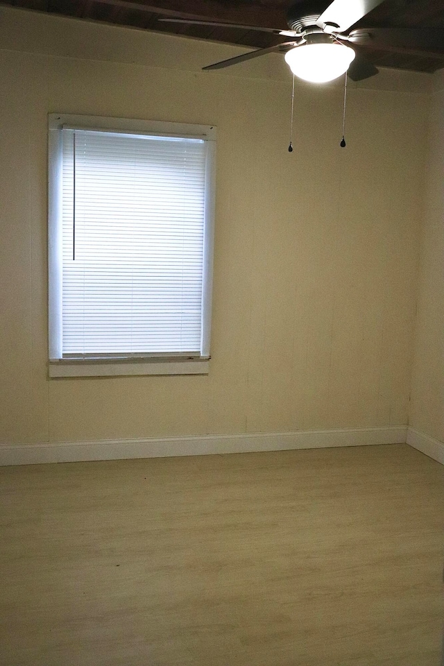 empty room with light hardwood / wood-style flooring, a wealth of natural light, and ceiling fan