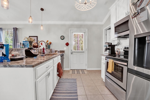 kitchen with appliances with stainless steel finishes, white cabinetry, and plenty of natural light