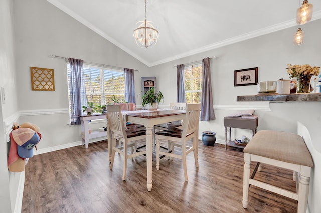 dining space featuring hardwood / wood-style floors, vaulted ceiling, crown molding, and plenty of natural light