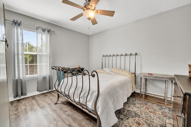 bedroom with hardwood / wood-style flooring and ceiling fan