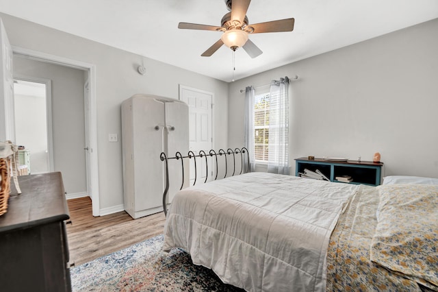 bedroom with ceiling fan and light wood-type flooring