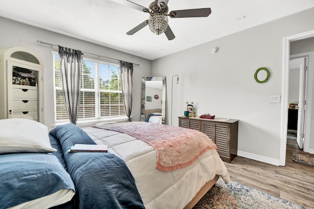 bedroom with ceiling fan and hardwood / wood-style flooring