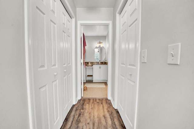 hallway with hardwood / wood-style floors