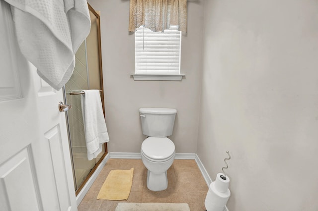 bathroom with toilet, tile patterned flooring, and an enclosed shower