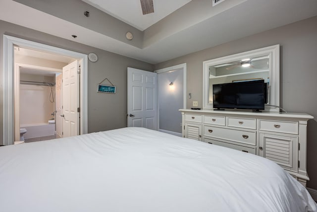 bedroom featuring ensuite bath and ceiling fan