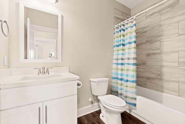 full bathroom with vanity, hardwood / wood-style floors, shower / tub combo, and toilet