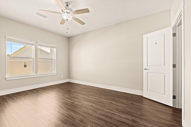 unfurnished room with ceiling fan and dark hardwood / wood-style flooring