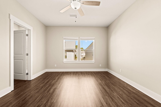 empty room with dark wood-type flooring and ceiling fan