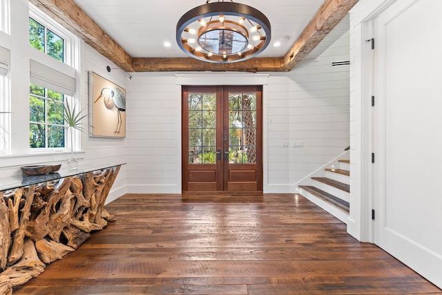 entryway featuring french doors, an inviting chandelier, wooden walls, and dark hardwood / wood-style floors