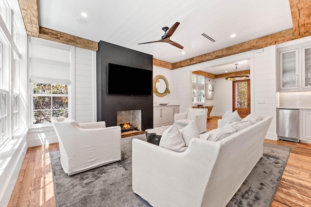 living room with hardwood / wood-style floors, a fireplace, and ceiling fan