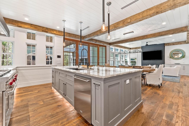 kitchen with a wealth of natural light, hanging light fixtures, and dark hardwood / wood-style flooring