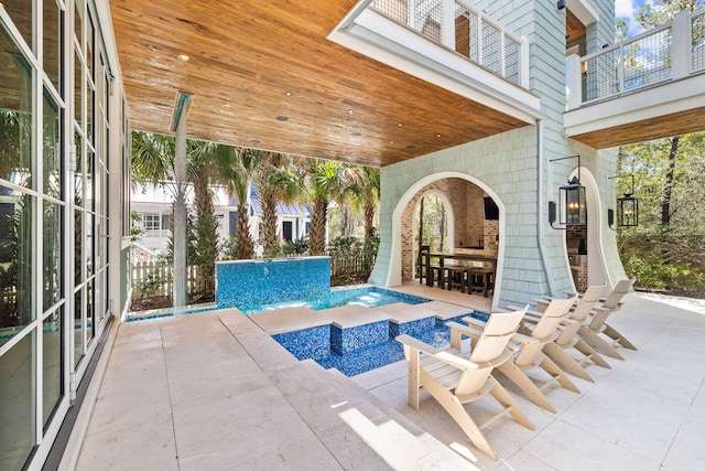 view of swimming pool with a patio and pool water feature