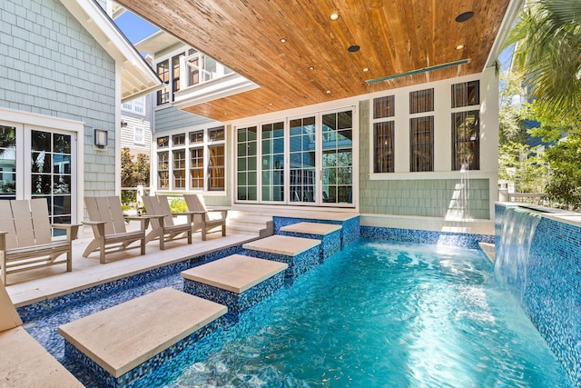 view of swimming pool featuring a patio and pool water feature