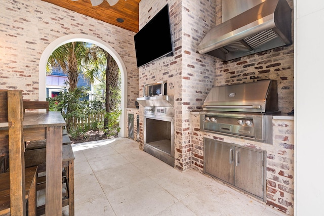 view of patio / terrace with an outdoor kitchen and a grill