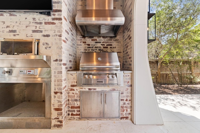 view of patio featuring a grill and an outdoor kitchen