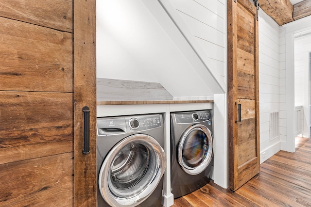 clothes washing area featuring washer and dryer and hardwood / wood-style floors