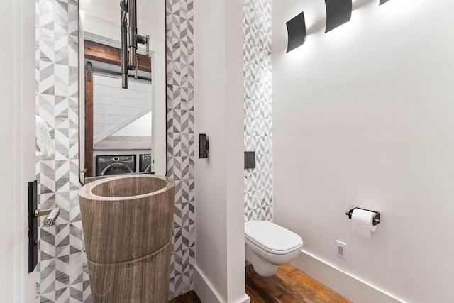 bathroom with toilet and hardwood / wood-style flooring