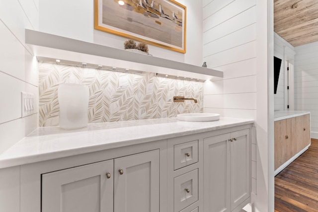 bathroom with vanity, wood ceiling, wood walls, and wood-type flooring