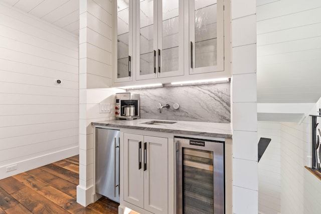 bar featuring white cabinetry, dark hardwood / wood-style flooring, stainless steel fridge, and beverage cooler