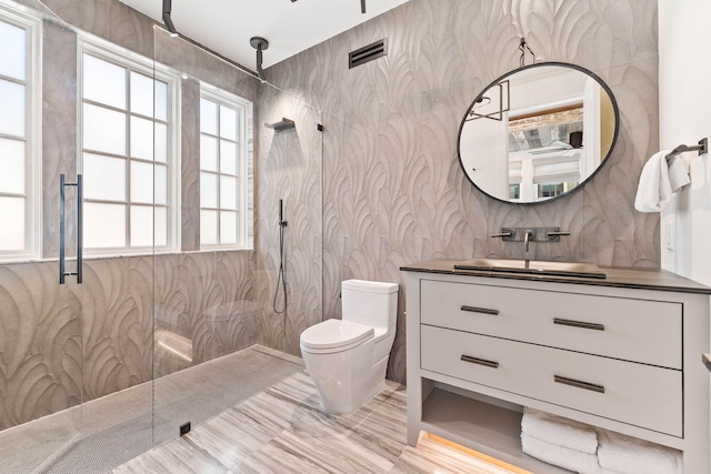 bathroom with toilet, walk in shower, tile walls, vanity, and hardwood / wood-style flooring