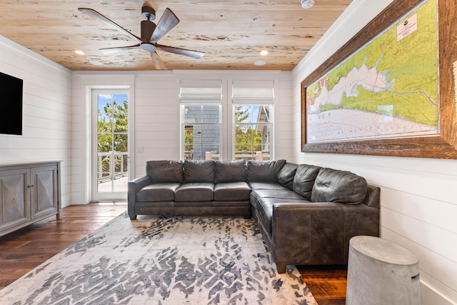 living room featuring ceiling fan, a healthy amount of sunlight, wooden ceiling, and dark hardwood / wood-style floors