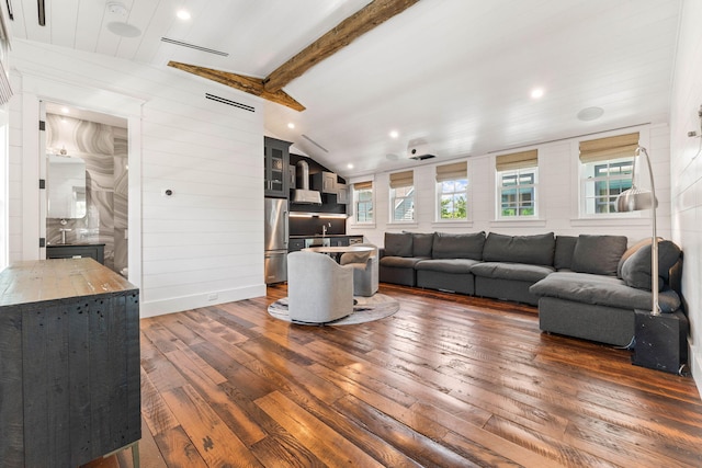 living room featuring vaulted ceiling with beams and dark hardwood / wood-style floors