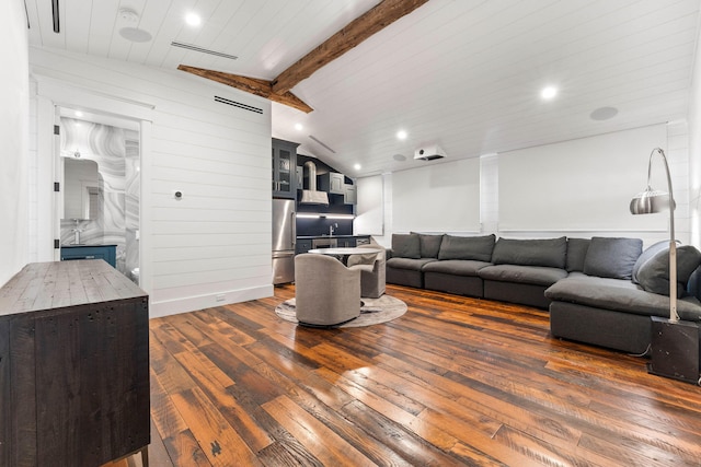 living room with lofted ceiling with beams, a fireplace, and dark hardwood / wood-style floors