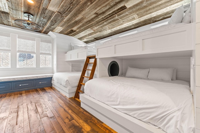 bedroom with lofted ceiling, dark wood-type flooring, and wooden walls