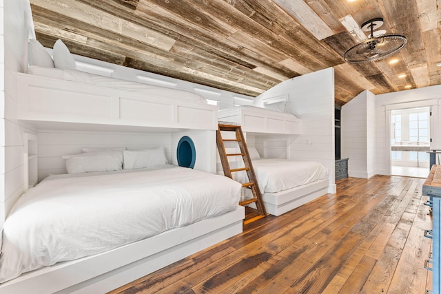 bedroom featuring lofted ceiling, wood ceiling, dark wood-type flooring, wooden walls, and a wood stove