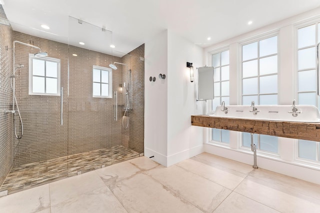 bathroom with vanity, tile patterned flooring, and tiled shower