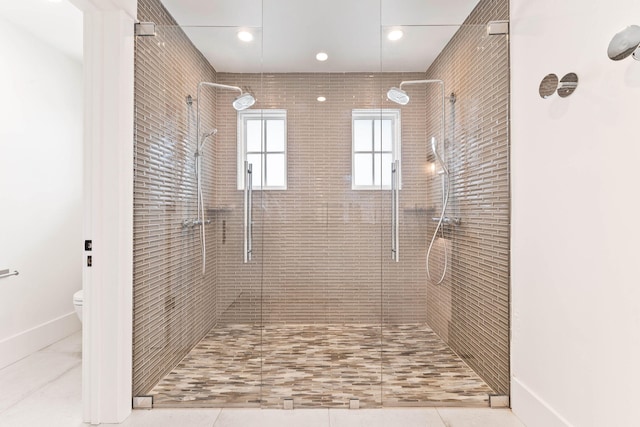 bathroom with toilet, walk in shower, and tile patterned floors