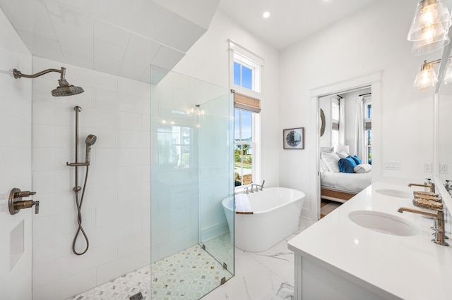 bathroom with vanity and shower with separate bathtub