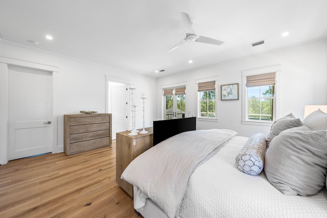 bedroom featuring crown molding, multiple windows, light wood-type flooring, and ceiling fan