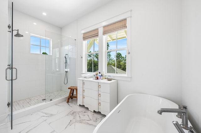 bathroom with vanity and independent shower and bath