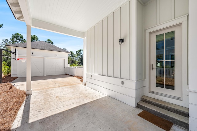 view of patio featuring a garage and an outbuilding