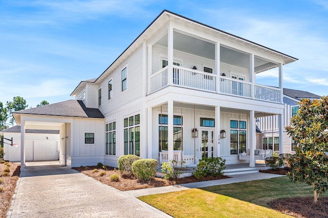 view of front of home featuring a front yard, covered porch, and a carport