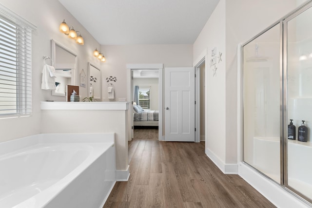 bathroom with plus walk in shower and wood-type flooring