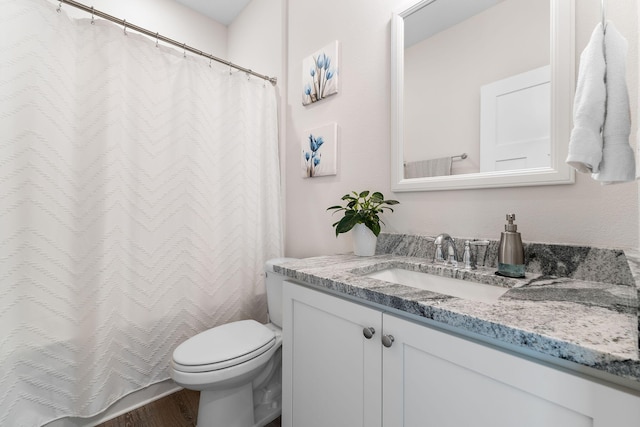 bathroom with vanity, hardwood / wood-style flooring, and toilet