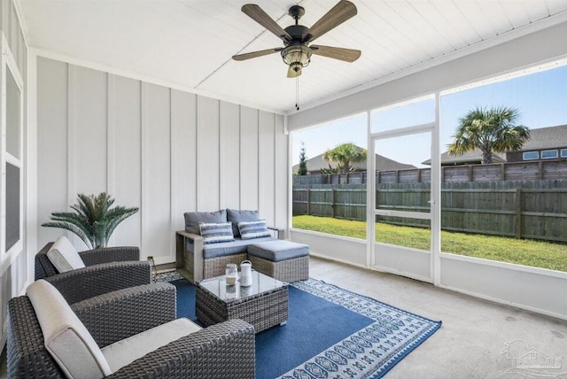 sunroom featuring wood ceiling, a healthy amount of sunlight, and ceiling fan