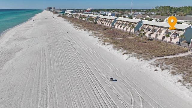 birds eye view of property featuring a view of the beach and a water view