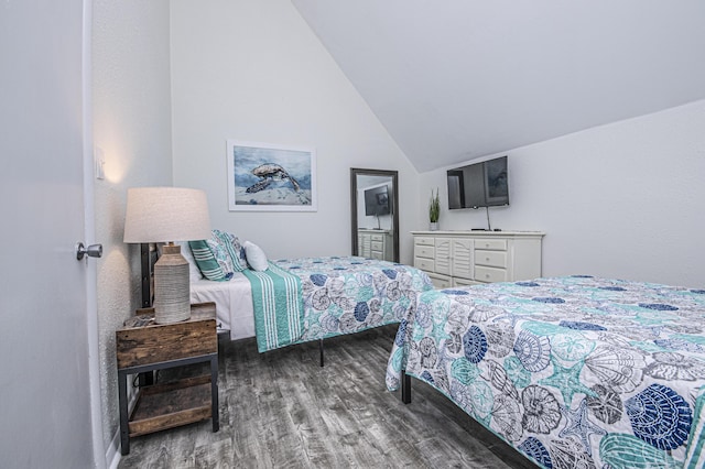 bedroom with lofted ceiling and dark hardwood / wood-style floors