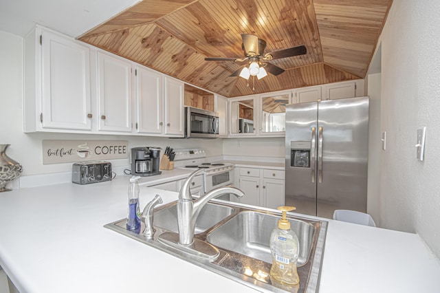 kitchen with lofted ceiling, appliances with stainless steel finishes, white cabinetry, wooden ceiling, and kitchen peninsula