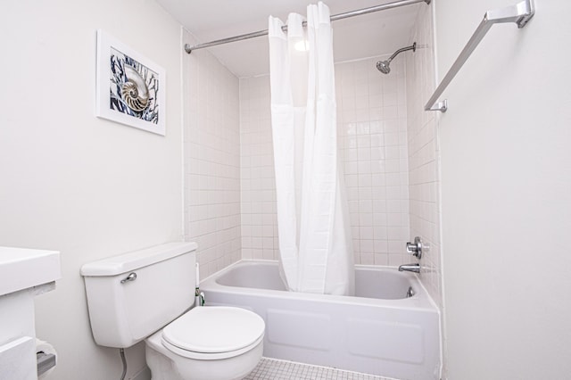 bathroom with shower / tub combo with curtain, tile patterned floors, and toilet