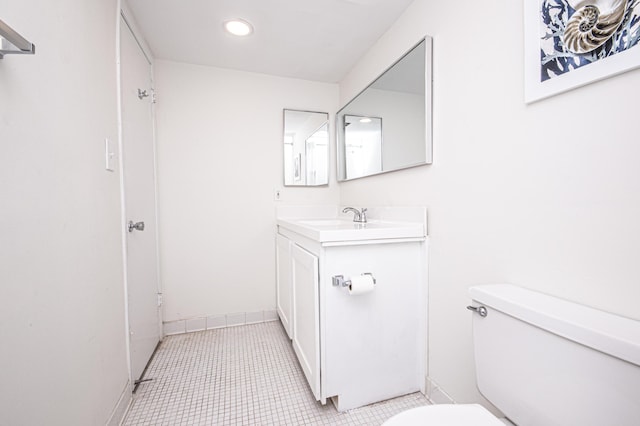 bathroom featuring tile patterned floors, vanity, and toilet