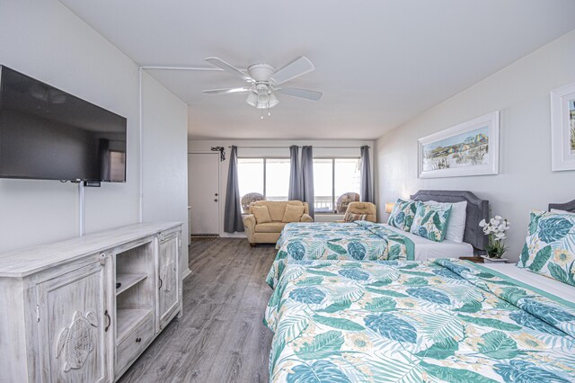 bedroom with ceiling fan and light hardwood / wood-style flooring