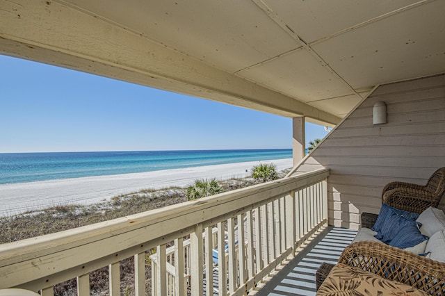 balcony featuring a water view and a view of the beach